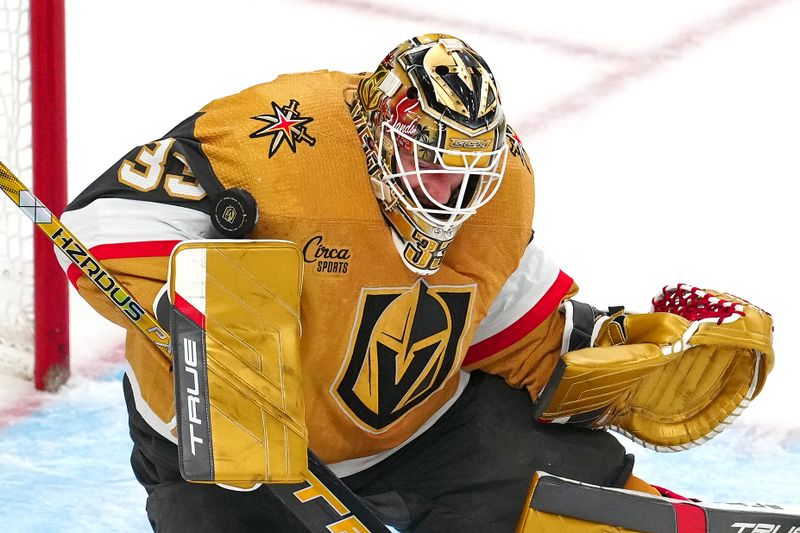 Apr 18, 2024; Las Vegas, Nevada, USA; Vegas Golden Knights goaltender Adin Hill (33) makes a save against the Anaheim Ducks during the third period at T-Mobile Arena. Mandatory Credit: Stephen R. Sylvanie-USA TODAY Sports