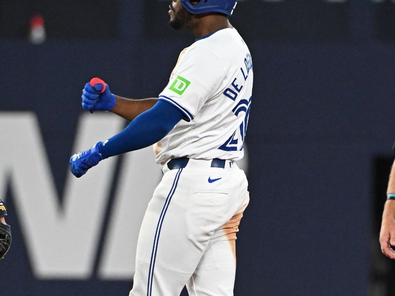 Aug 11, 2024; Toronto, Ontario, CAN; Toronto Blue Jays third base Luis De Los Santos (20) celebrates a RBI double in the eighth inning against the Oakland Athletics at Rogers Centre. Mandatory Credit: Gerry Angus-USA TODAY Sports