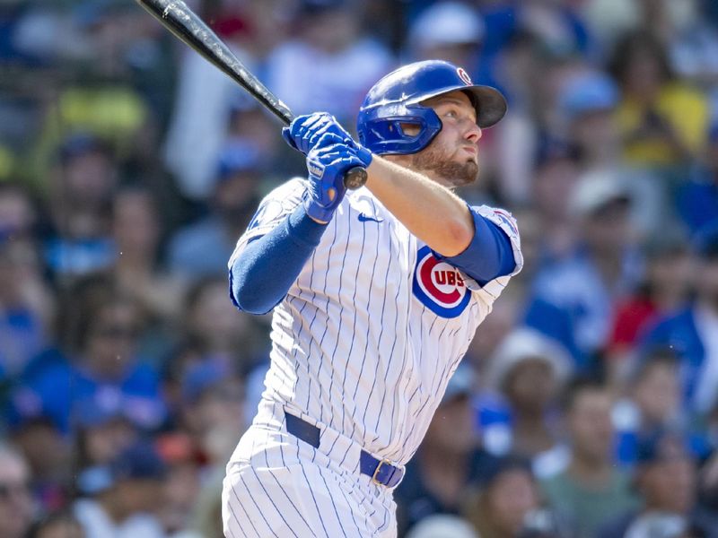 Aug 17, 2024; Chicago, Illinois, USA; Chicago Cubs first base Michael Busch (29) hits a two-run triple during the fifth inning against the Toronto Blue Jays at Wrigley Field. Mandatory Credit: Patrick Gorski-USA TODAY Sports