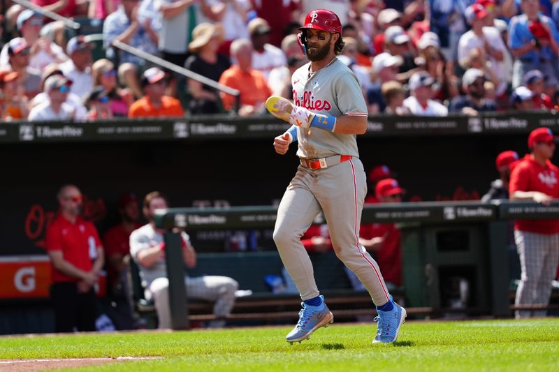 Jun 16, 2024; Baltimore, Maryland, USA; Philadelphia Phillies first baseman Bryce Harper (3) scores a run on Philadelphia Phillies third baseman Alec Bohm (not pictured) RBI double against the Baltimore Orioles during the seventh inning at Oriole Park at Camden Yards. Mandatory Credit: Gregory Fisher-USA TODAY Sports