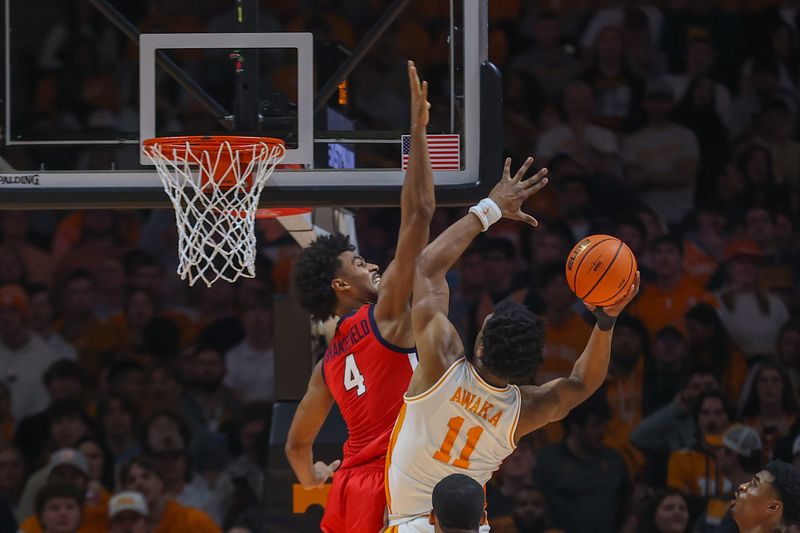 Jan 6, 2024; Knoxville, Tennessee, USA; Tennessee Volunteers forward Tobe Awaka (11) goes to the basket against Mississippi Rebels forward Jaemyn Brakefield (4) during the second half at Thompson-Boling Arena at Food City Center. Mandatory Credit: Randy Sartin-USA TODAY Sports