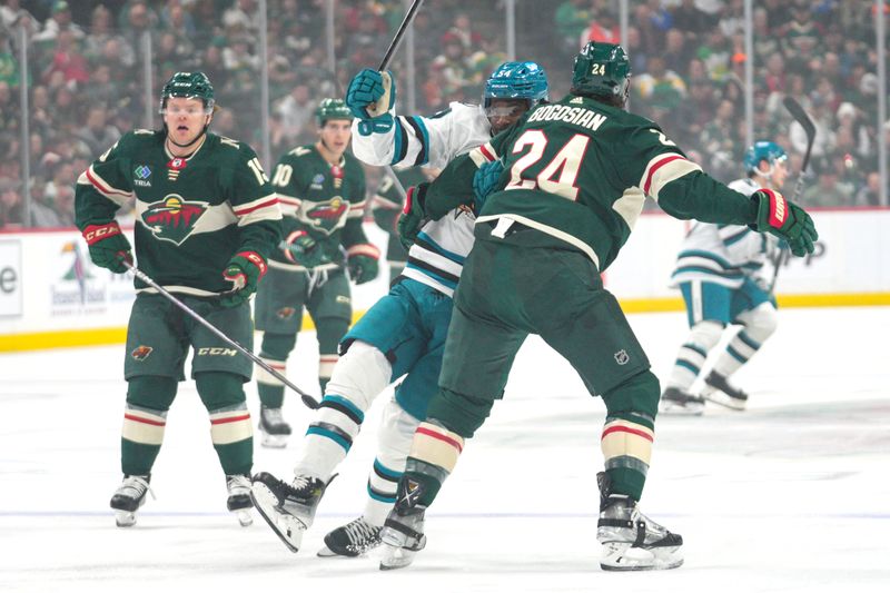 Mar 3, 2024; Saint Paul, Minnesota, USA; Minnesota Wild defenseman Zach Bogosian (24) holds San Jose Sharks right wing Givani Smith (54) in the first period at Xcel Energy Center. Mandatory Credit: Matt Blewett-USA TODAY Sports