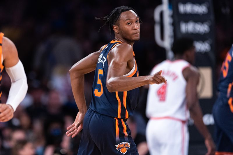 NEW YORK, NEW YORK - MARCH 29: Immanuel Quickley #5 of the New York Knicks points to a teammate during the second quarter of the game against the Miami Heat at Madison Square Garden on March 29, 2023 in New York City. NOTE TO USER: User expressly acknowledges and agrees that, by downloading and or using this photograph, User is consenting to the terms and conditions of the Getty Images License Agreement. (Photo by Dustin Satloff/Getty Images)