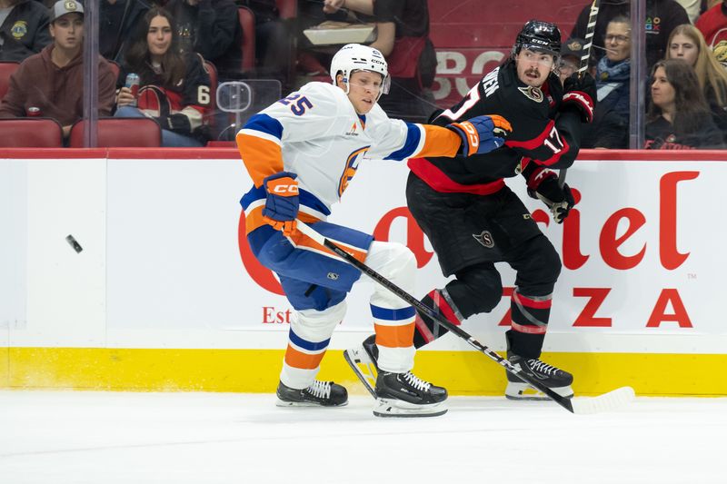 Nov 7, 2024; Ottawa, Ontario, CAN; Ottawa Senators right wing Zack MacEwen (17) moves the puck away from New York Islanders defenseman Dennis Cholowski (25) in the first period at the Canadian Tire Centre. Mandatory Credit: Marc DesRosiers-Imagn Images