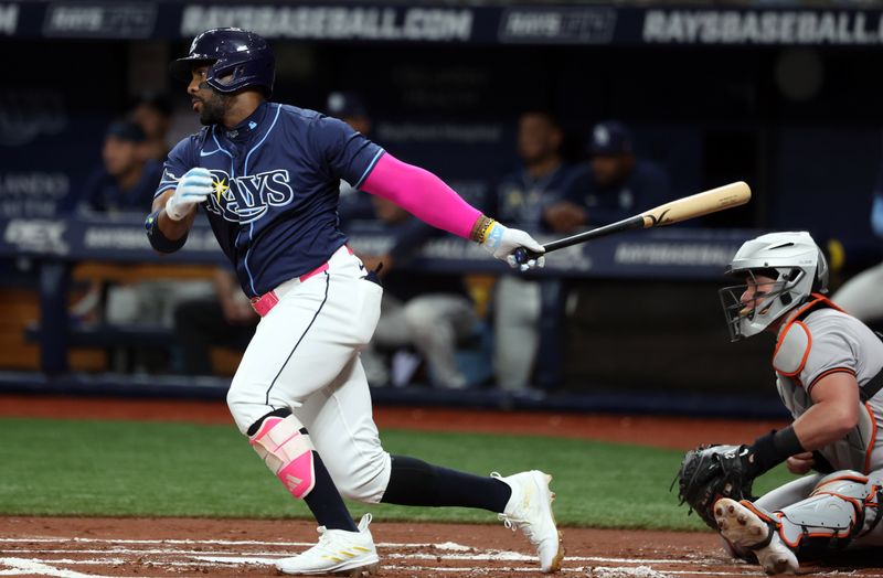 Jun 10, 2024; St. Petersburg, Florida, USA;  Tampa Bay Rays first base Yandy Díaz (2) singles against the Baltimore Orioles during the first inning at Tropicana Field. Mandatory Credit: Kim Klement Neitzel-USA TODAY Sports