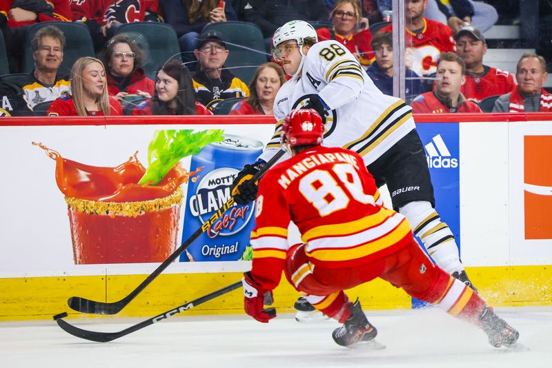 Feb 22, 2024; Calgary, Alberta, CAN; Boston Bruins right wing David Pastrnak (88) controls the puck against Calgary Flames left wing Andrew Mangiapane (88) during the first period at Scotiabank Saddledome. Mandatory Credit: Sergei Belski-USA TODAY Sports