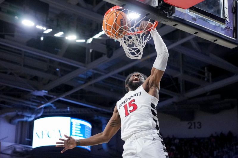 Dec 19, 2023; Cincinnati, Ohio, USA; Cincinnati Bearcats forward John Newman III (15) dunks the ball against Merrimack Warriors forward Jaylen Stinson (1) in the first half at Fifth Third Arena. Mandatory Credit: Aaron Doster-USA TODAY Sports