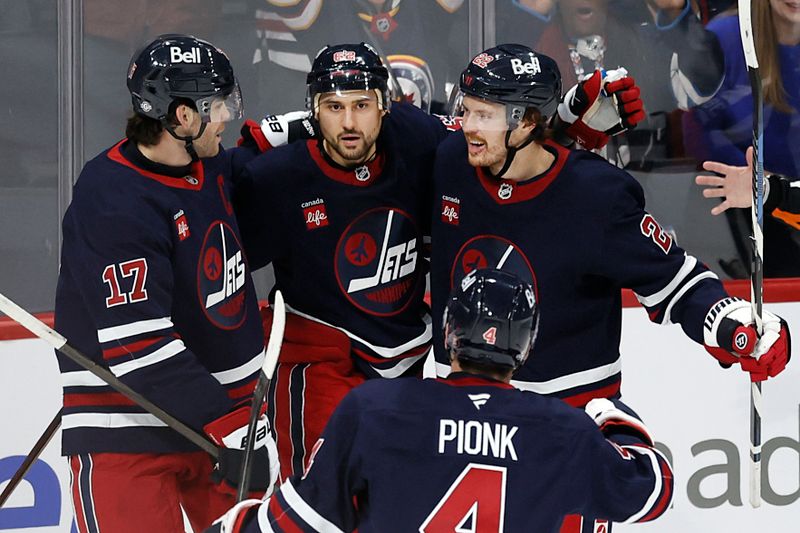 Oct 20, 2024; Winnipeg, Manitoba, CAN; Winnipeg Jets center Mason Appleton (22) celebrates his third period goal with his teammates against the Pittsburgh Penguins at Canada Life Centre. Mandatory Credit: James Carey Lauder-Imagn Images