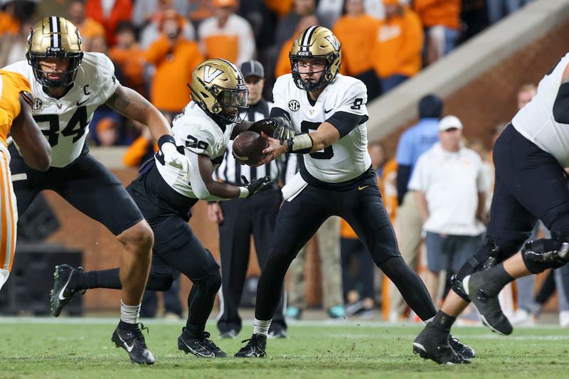 Nov 25, 2023; Knoxville, Tennessee, USA; Vanderbilt Commodores quarterback Ken Seals (8) hands the ball off to running back Sedrick Alexander (28) against the Tennessee Volunteers during the second half at Neyland Stadium. Mandatory Credit: Randy Sartin-USA TODAY Sports