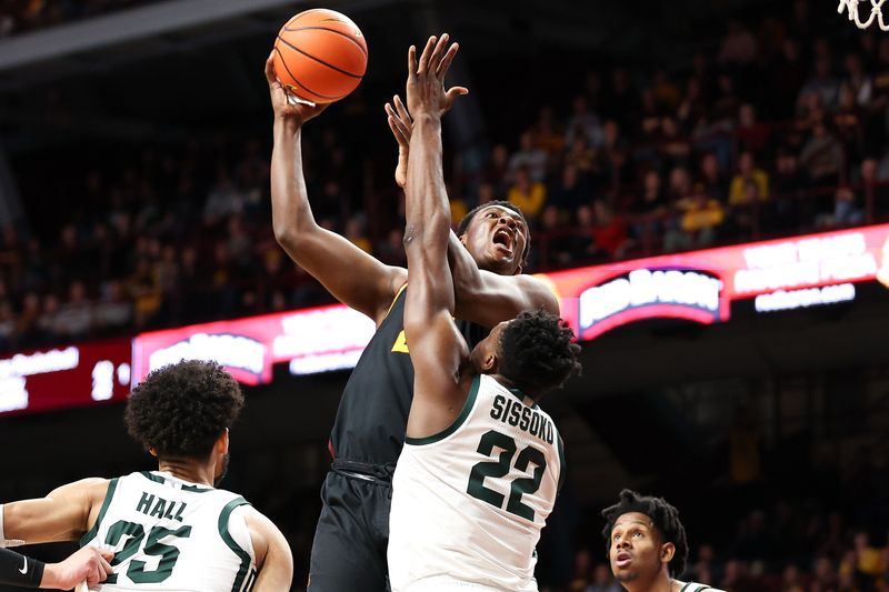 Feb 6, 2024; Minneapolis, Minnesota, USA; Minnesota Golden Gophers forward Pharrel Payne (21) shoots as Michigan State Spartans center Mady Sissoko (22) defends during the first half at Williams Arena. Mandatory Credit: Matt Krohn-USA TODAY Sports