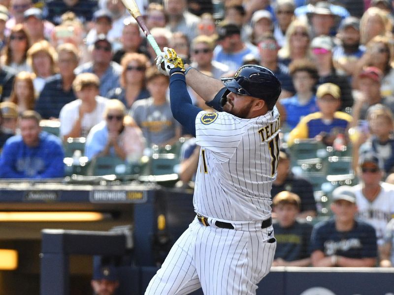 Aug 27, 2023; Milwaukee, Wisconsin, USA; Milwaukee Brewers first baseman Rowdy Tellez (11) hits a double in the sixth inning against the San Diego Padres at American Family Field. Mandatory Credit: Michael McLoone-USA TODAY Sports