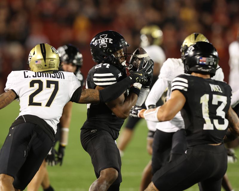 Oct 19, 2024; Ames, Iowa, USA; Iowa State Cyclones running back Abu Sama III (24) catches a pass in front of UCF Knights defensive back Chasen Johnson (27) at Jack Trice Stadium. The Cyclones beat the Knights 38 to 35.  Mandatory Credit: Reese Strickland-Imagn Images