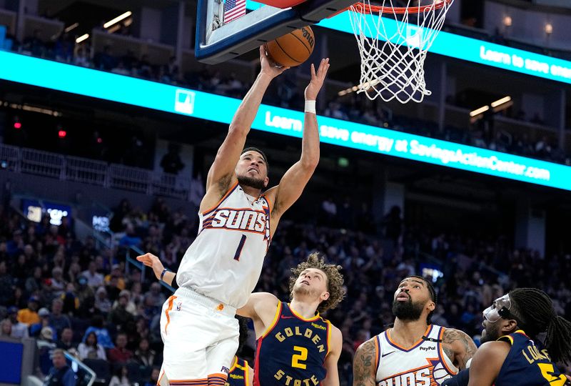 SAN FRANCISCO, CALIFORNIA - JANUARY 31: Devin Booker #1 of the Phoenix Suns shoots over Brandin Podziemski #2 of the Golden State Warriors during the second half at Chase Center on January 31, 2025 in San Francisco, California. NOTE TO USER: User expressly acknowledges and agrees that, by downloading and or using this photograph, User is consenting to the terms and conditions of the Getty Images License Agreement. (Photo by Thearon W. Henderson/Getty Images)