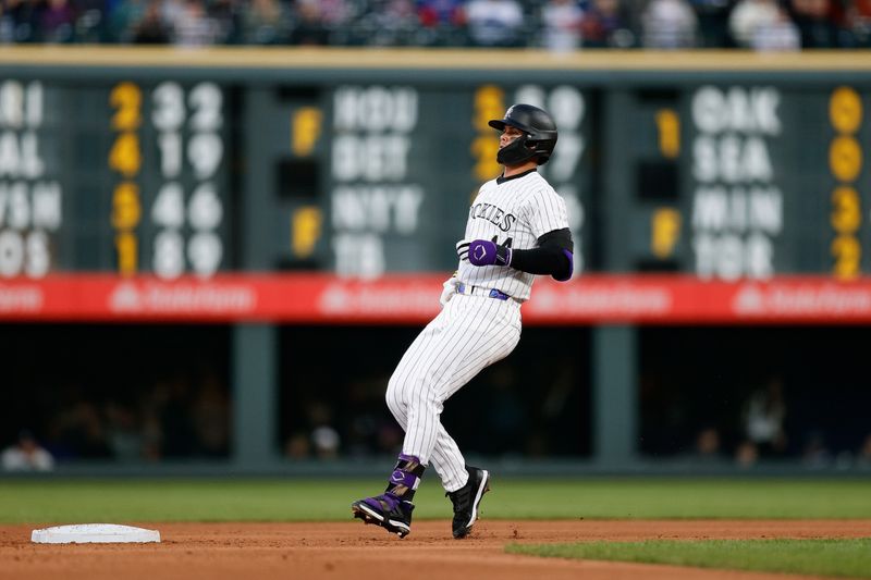 May 10, 2024; Denver, Colorado, USA; Colorado Rockies shortstop Ezequiel Tovar (14) holds up at second on a double in the fifth inning against the Texas Rangers at Coors Field. Mandatory Credit: Isaiah J. Downing-USA TODAY Sports