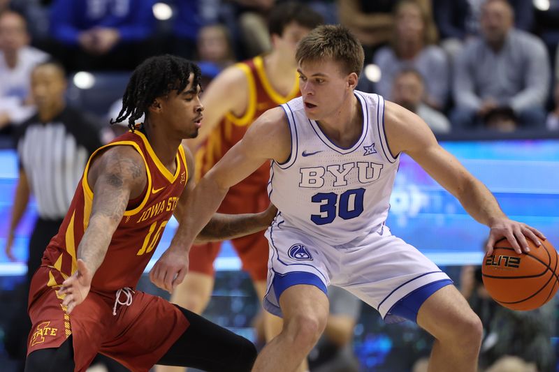 Jan 16, 2024; Provo, Utah, USA; Brigham Young Cougars guard Dallin Hall (30) posts up against Iowa State Cyclones guard Keshon Gilbert (10) during the second half at Marriott Center. Mandatory Credit: Rob Gray-USA TODAY Sports