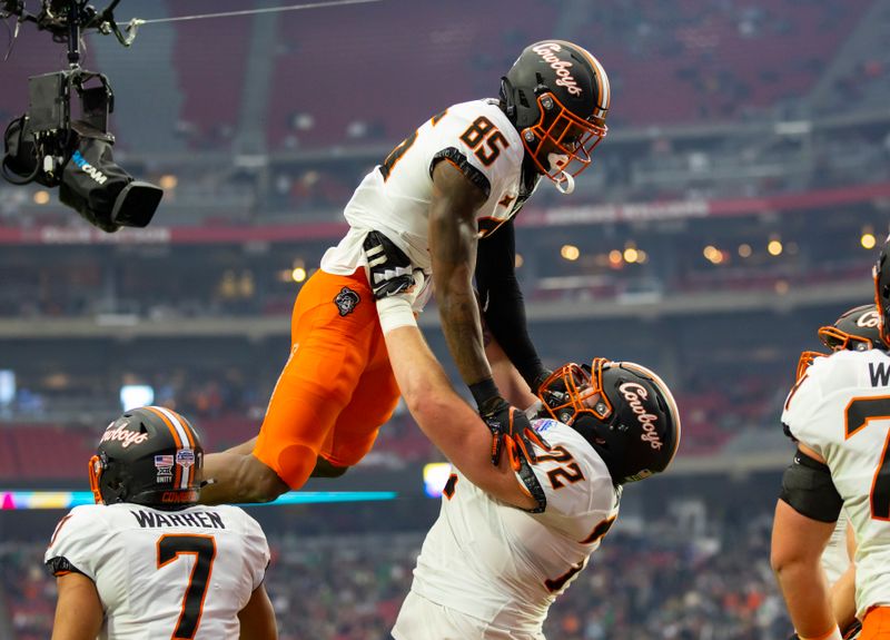 Jan 1, 2022; Glendale, Arizona, USA; Oklahoma State Cowboys wide receiver Jaden Bray (85) celebrates with offensive lineman Josh Sills (72( after scoring a touchdown against the Notre Dame Fighting Irish in the first half during the 2022 Fiesta Bowl at State Farm Stadium. Mandatory Credit: Mark J. Rebilas-USA TODAY Sports