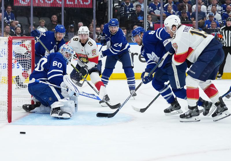 May 7, 2025; Toronto, Ontario, CAN;Toronto Maple Leafs left wing Scott Laughton (24) battles for the puck with Florida Panthers center Sam Bennett (9) during the second period in game two of the second round of the 2025 Stanley Cup Playoffs at Scotiabank Arena. Mandatory Credit: Nick Turchiaro-Imagn Images