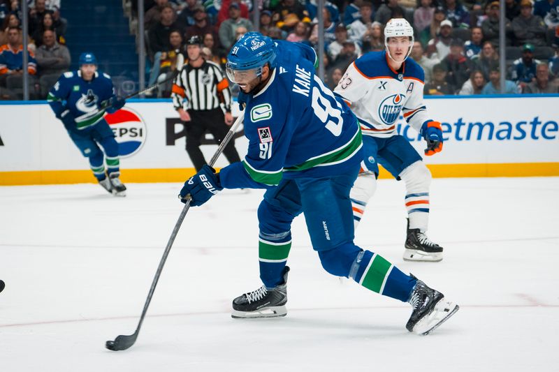Oct 3, 2025; Vancouver, British Columbia, CAN; Vancouver Canucks forward Evander Kane (91) shoots against the Edmonton Oilers in the first period at Rogers Arena. Mandatory Credit: Bob Frid-Imagn Images
