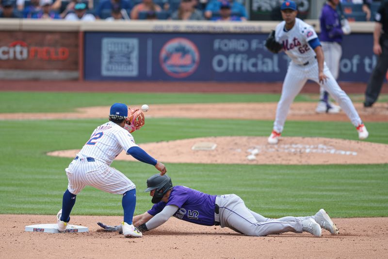 Jul 14, 2024; New York City, New York, USA; Colorado Rockies right fielder Hunter Goodman (15) dives safely back to second base as New York Mets shortstop Francisco Lindor (12) catches a throw from starting pitcher Jose Quintana (62) during the fifth inning at Citi Field. Mandatory Credit: Vincent Carchietta-USA TODAY Sports