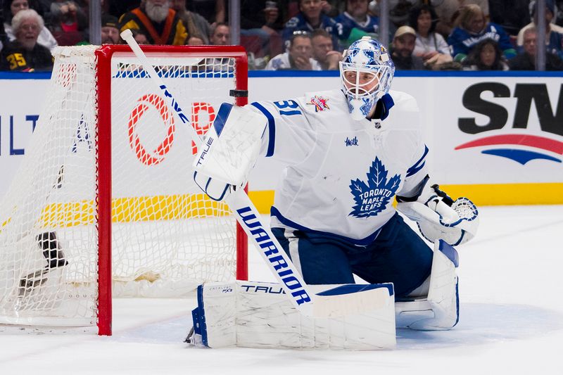 Jan 20, 2024; Vancouver, British Columbia, CAN; Toronto Maple Leafs goalie Martin Jones (31) watches the shot from Vancouver Canucks forward Elias Pettersson (40) rebound off the post in the third period at Rogers Arena. Canucks won 6-4. Mandatory Credit: Bob Frid-USA TODAY Sports