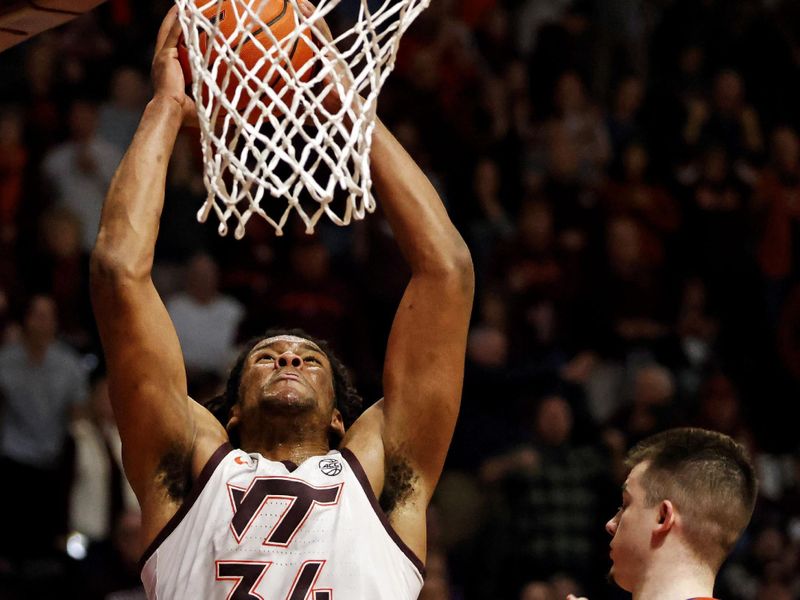 Jan 10, 2024; Blacksburg, Virginia, USA; Virginia Tech Hokies forward Mylyjael Poteat (34) dunks the ball against Clemson Tigers guard Joseph Girard III (11) during the second half at Cassell Coliseum. Mandatory Credit: Peter Casey-USA TODAY Sports