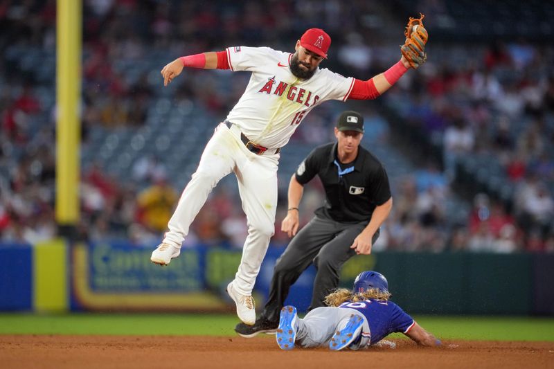 May 6, 2023; Anaheim, California, USA; Texas Rangers designated hitter Travis Jankowski (16) slides into second base to beat a throw to Los Angeles Angels shortstop Luis Guillorme (15) for a stolen base in the sixth inning at Angel Stadium. Mandatory Credit: Kirby Lee-USA TODAY Sports