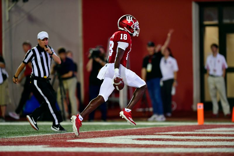 Sep 11, 2021; Bloomington, Indiana, USA; Indiana Hoosiers defensive lineman Jonathan King (18) scores a touchdown after a blocked punt against the Idaho Vandals during the first quarter at Memorial Stadium. Mandatory Credit: Marc Lebryk-USA TODAY Sports