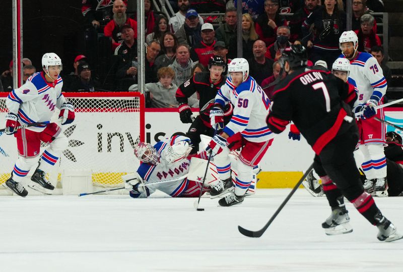 Mar 12, 2024; Raleigh, North Carolina, USA; New York Rangers left wing Will Cuylle (50) picks the puck up in front of goaltender Igor Shesterkin (31) against the Carolina Hurricanes during the second period at PNC Arena. Mandatory Credit: James Guillory-USA TODAY Sports