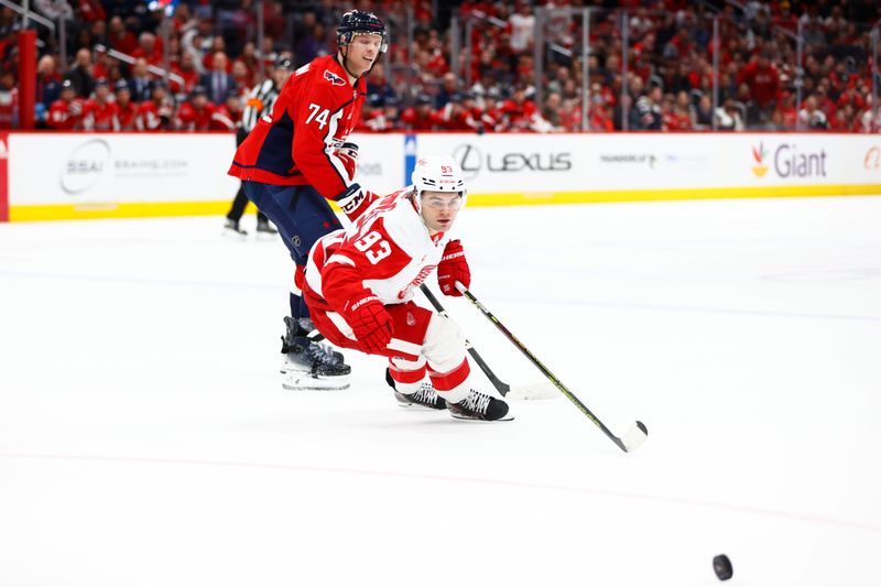 Mar 26, 2024; Washington, District of Columbia, USA; Detroit Red Wings right wing Alex DeBrincat (93) watches the puck in front of Washington Capitals defenseman John Carlson (74) during the third period at Capital One Arena. Mandatory Credit: Amber Searls-USA TODAY Sports