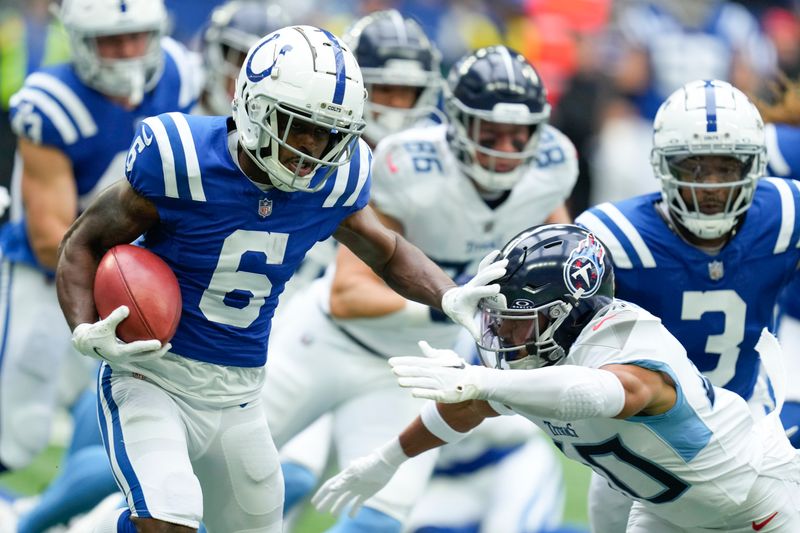 Indianapolis Colts wide receiver Isaiah McKenzie (6) stiff arms Tennessee Titans cornerback Anthony Kendall, right, during the first half of an NFL football game, Sunday, Oct. 8, 2023, in Indianapolis. (AP Photo/Michael Conroy)