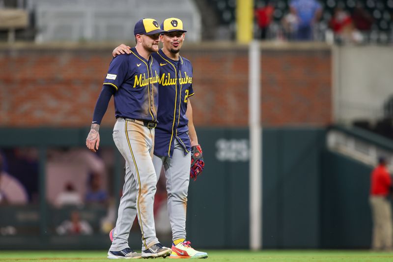 Aug 6, 2024; Atlanta, Georgia, USA; Milwaukee Brewers second baseman Brice Turang (2) and shortstop Willy Adames (27) celebrate after a victory against the Atlanta Braves at Truist Park. Mandatory Credit: Brett Davis-USA TODAY Sports