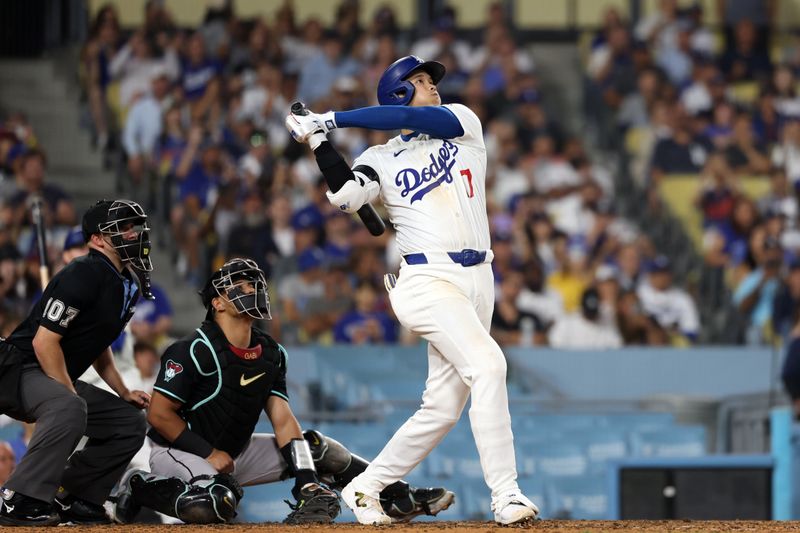 Jul 2, 2024; Los Angeles, California, USA;  Los Angeles Dodgers designated hitter Shohei Ohtani (17) hits a two-run home run during the seventh inning against the Arizona Diamondbacks at Dodger Stadium. Mandatory Credit: Kiyoshi Mio-USA TODAY Sports