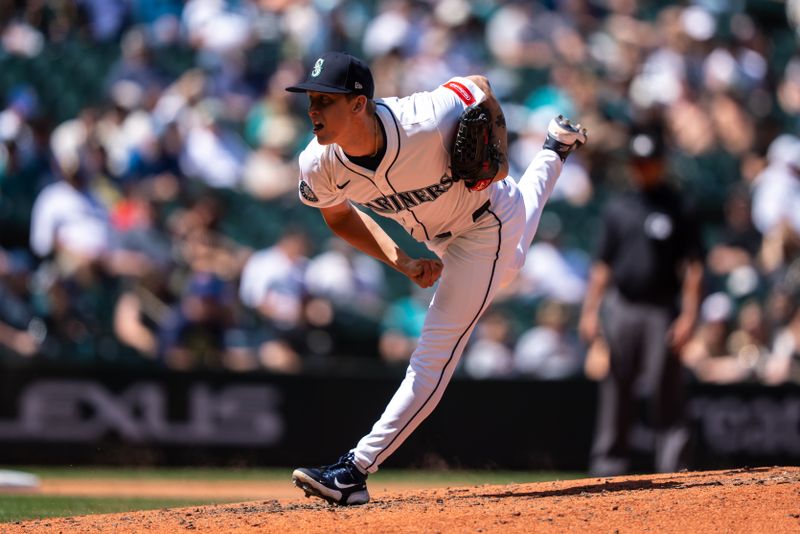 Jun 5, 2025; Seattle, Washington, USA;  Reliever Casey Legumina (64) delivers a pitch during the ninth inning against the Baltimore Orioles at T-Mobile Park. Mandatory Credit: Stephen Brashear-Imagn Images