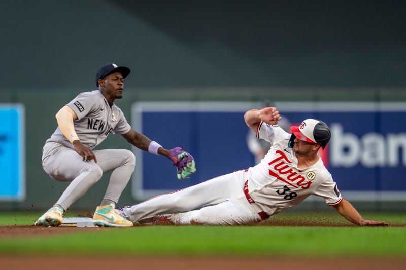 Sep 15, 2025; Minneapolis, Minnesota, USA; Minnesota Twins right fielder Matt Wallner (38) slides into second base before New York Yankees second baseman Jazz Chisholm Jr. (13) can make a tag in the second inning at Target Field. Mandatory Credit: Jesse Johnson-Imagn Images