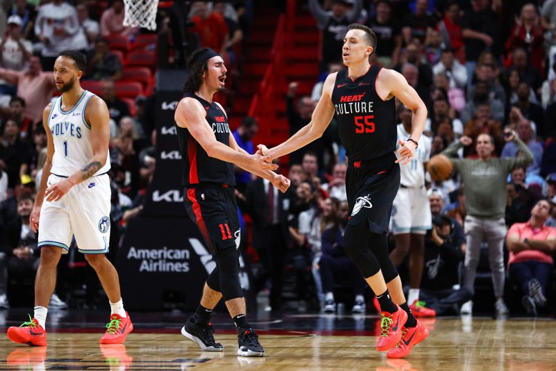 MIAMI, FLORIDA - DECEMBER 18: Jaime Jaquez Jr. #11 and Duncan Robinson #55 of the Miami Heat celebrate during the second quarter of the game against the Minnesota Timberwolves at Kaseya Center on December 18, 2023 in Miami, Florida. NOTE TO USER: User expressly acknowledges and agrees that, by downloading and or using this photograph, User is consenting to the terms and conditions of the Getty Images License Agreement. (Photo by Megan Briggs/Getty Images)