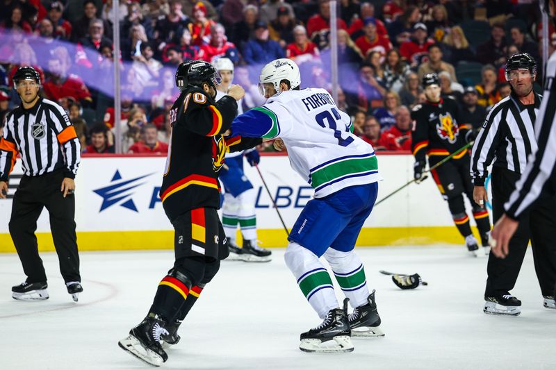 Dec 31, 2024; Calgary, Alberta, CAN; Vancouver Canucks defenseman Derek Forbort (27) and Calgary Flames left wing Ryan Lomberg (70) fights during the second period at Scotiabank Saddledome. Mandatory Credit: Sergei Belski-Imagn Images
