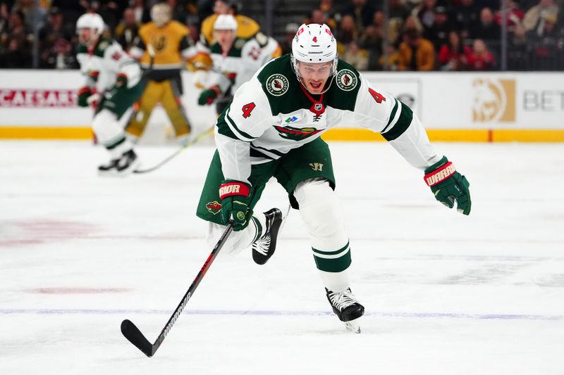 Feb 12, 2024; Las Vegas, Nevada, USA; Minnesota Wild defenseman Jon Merrill (4) skates against the Vegas Golden Knights during the first period at T-Mobile Arena. Mandatory Credit: Stephen R. Sylvanie-USA TODAY Sports