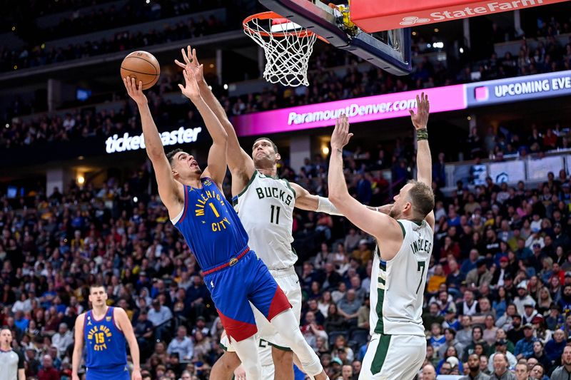 DENVER, CO - MARCH 25:  Michael Porter Jr. #1 of the Denver Nuggets scores under defense by Brook Lopez #11 of the Milwaukee Bucks in the first half of a game at Ball Arena on March 25, 2023 in Denver, Colorado. NOTE TO USER: User expressly acknowledges and agrees that, by downloading and or using this photograph, User is consenting to the terms and conditions of the Getty Images License Agreement. (Photo by Dustin Bradford/Getty Images)