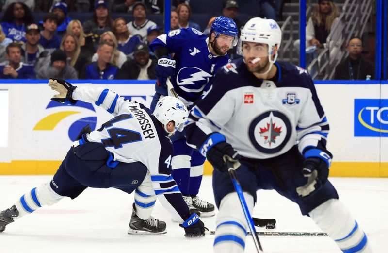 Jan 29, 2026; Tampa, Florida, USA; Tampa Bay Lightning right wing Nikita Kucherov (86) shoots as Winnipeg Jets defenseman Josh Morrissey (44) defends during the third period at Benchmark International Arena. Mandatory Credit: Kim Klement Neitzel-Imagn Images