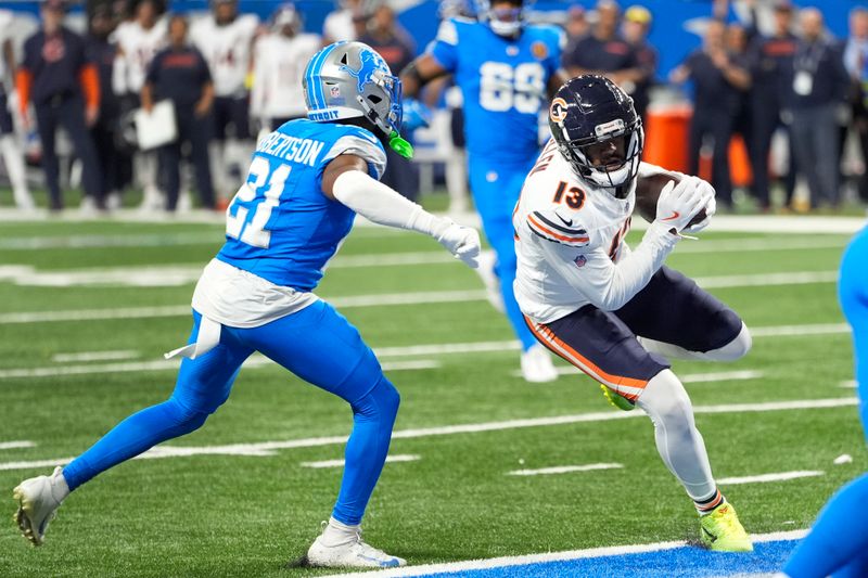 Chicago Bears wide receiver Keenan Allen (13) scores on a touchdown reception as Detroit Lions cornerback Amik Robertson (21) defends during the second half of an NFL football game, Sunday, Nov. 17, 2024, in Detroit. (AP Photo/Carlos Osorio)