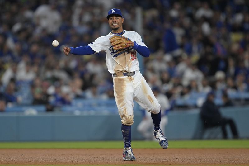 Apr 2, 2024; Los Angeles, California, USA;  Los Angeles Dodgers shortstop Mookie Betts (50) throws San Francisco Giants shortstop Nick Ahmed (16) out at first in the seventh inning at Dodger Stadium. Mandatory Credit: Jayne Kamin-Oncea-USA TODAY Sports