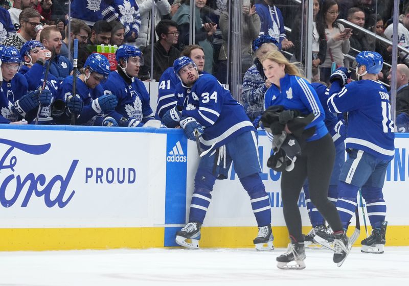 Feb 15, 2024; Toronto, Ontario, CAN; Toronto Maple Leafs center Auston Matthews (34) waits at the bench after scoring his third goal as the ice crew gather the hats off the ice against the Philadelphia Flyers during the second period at Scotiabank Arena. Mandatory Credit: Nick Turchiaro-USA TODAY Sports