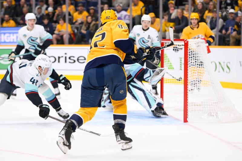 Oct 15, 2024; Nashville, Tennessee, USA;  Nashville Predators center Tommy Novak (82) scores past Seattle Kraken goaltender Joey Daccord (35) during the first period at Bridgestone Arena. Mandatory Credit: Steve Roberts-Imagn Images