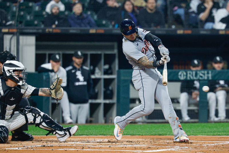 Jun 4, 2025; Chicago, Illinois, USA; Detroit Tigers center fielder Javier Baez (28) hits an RBI-single against the Chicago White Sox during the first inning at Rate Field. Mandatory Credit: Kamil Krzaczynski-Imagn Images