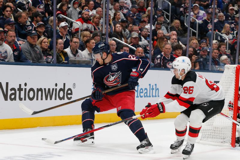 Oct 13, 2025; Columbus, Ohio, USA; Columbus Blue Jackets center Mathieu Olivier (24) reverses away from the check of New Jersey Devils center Jack Hughes (86) during the first period at Nationwide Arena. Mandatory Credit: Russell LaBounty-Imagn Images