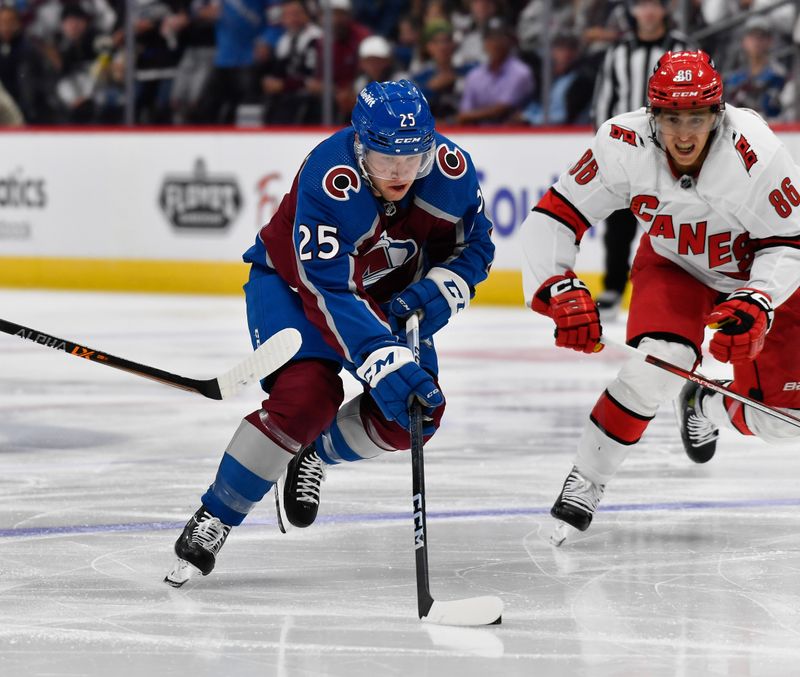 Oct 21, 2023; Denver, Colorado, USA; Colorado Avalanche right wing Logan O'Connor (25) skates the puck down ice as Carolina Hurricanes left wing Teuvo Teravainen (86) gives chase in the second period at Ball Arena. Mandatory Credit: John Leyba-USA TODAY Sports