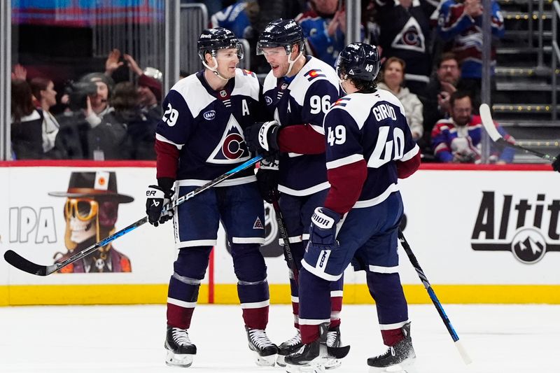 Dec 31, 2024; Denver, Colorado, USA; Colorado Avalanche right wing Mikko Rantanen (96) celebrates his goal with center Nathan MacKinnon (29) and defenseman Samuel Girard (49) in the third period against the Winnipeg Jets at Ball Arena. Mandatory Credit: Ron Chenoy-Imagn Images