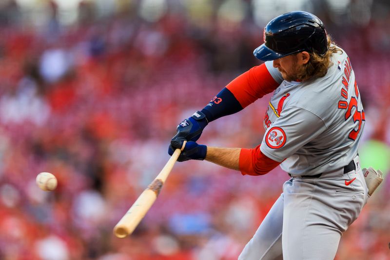 Aug 14, 2024; Cincinnati, Ohio, USA; St. Louis Cardinals second baseman Brendan Donovan (33) hits a single against the Cincinnati Reds in the second inning at Great American Ball Park. Mandatory Credit: Katie Stratman-USA TODAY Sports