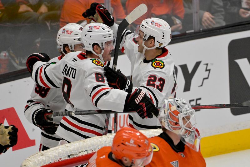 Nov 3, 2024; Anaheim, California, USA; Chicago Blackhawks center Connor Bedard (98) and center Ryan Donato (8) congratulate center Philipp Kurashev (23) after scoring a goal in the third period against the Anaheim Ducks at Honda Center. Mandatory Credit: Jayne Kamin-Oncea-Imagn Images