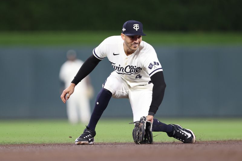 Oct 11, 2023; Minneapolis, Minnesota, USA; Minnesota Twins shortstop Carlos Correa (4) fields a ground ball in the third inning against the Houston Astros during game four of the ALDS for the 2023 MLB playoffs at Target Field. Mandatory Credit: Jesse Johnson-USA TODAY Sports